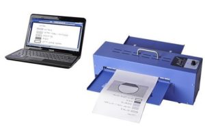 Photo of a laptop computer and a PIAF brand tactile image maker